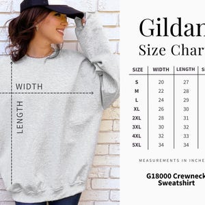 May include: A light gray Gildan G18000 crewneck sweatshirt. The image includes a size chart with measurements in inches for sizes S to 5XL. The chart shows width, length, and sleeve measurements. The sweatshirt is shown on a person.