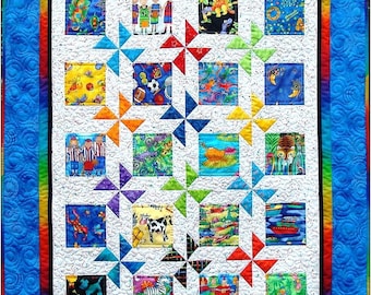 May include: A colorful quilt with a white background and a blue border. The quilt is made up of squares with different animal and nature-themed patterns. The squares are arranged in a grid pattern, and the quilt is quilted with a white thread.