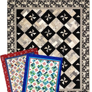 May include: Three quilt patterns with a black and white geometric design, a red and white patchwork design, and a blue and green patchwork design. The quilt patterns are labeled "Simply Majestic".