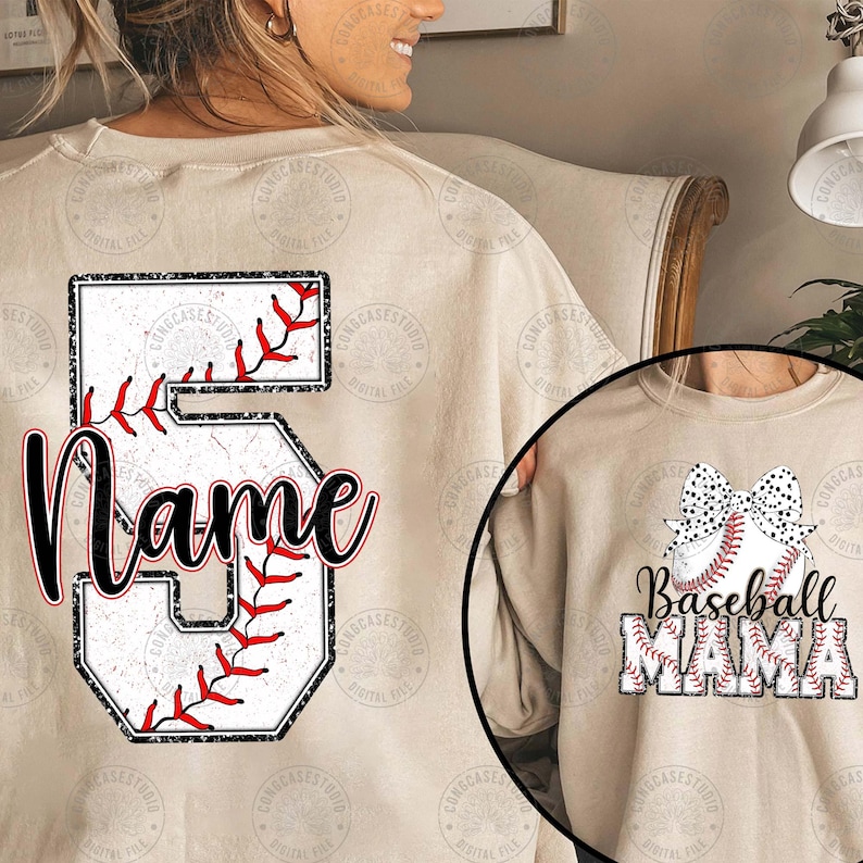 May include: A beige sweatshirt with a baseball-themed design. The back of the sweatshirt features a large number 5 with a baseball stitched into it. The front of the sweatshirt features a baseball with a bow and the text "Baseball Mama".