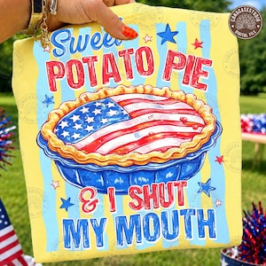 May include: Yellow t-shirt with a graphic of a sweet potato pie decorated with the American flag. The text reads "Sweet Potato Pie & I Shut My Mouth" in red and blue. Stars and stripes decorate the background.
