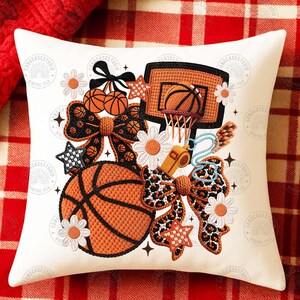 May include: White cushion with a basketball design. It features a basketball, hoop, bows, stars, and daisies in orange, black, and white. Includes a whistle and the text "DIGITAL FILE".