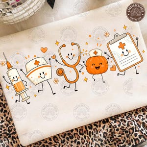 May include: A white fabric surface featuring a graphic print of five animated medical-themed characters: a syringe, a nurse cap, a stethoscope, a pumpkin wearing a nurse cap, and a clipboard, all rendered in shades of orange and black.