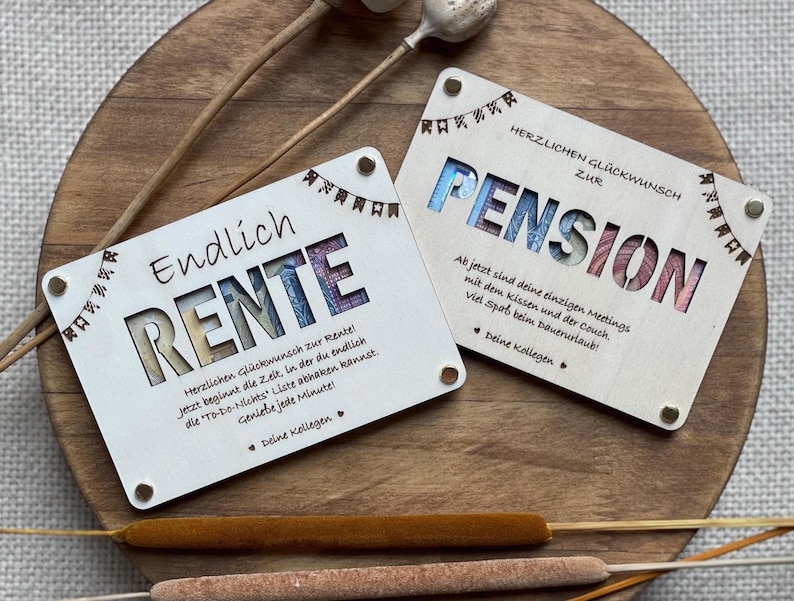 May include: Two wooden cards with a retirement theme. The first card says "Endlich Rente" which translates to "Finally Retirement" in English. The second card says "Herzlichen Gl&uuml;ckwunsch zur Pension" which translates to "Congratulations on your Pension" in English. Both cards have a colorful design with a floral pattern.