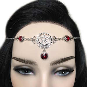 May include: Silver headband with a pentagram charm and red crystal accents. The headband is adorned with a Celtic knot design.