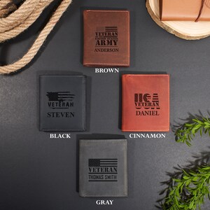 May include: Four rectangular leather wallets in brown, black, cinnamon, and gray. Each wallet features a laser-engraved design including an American flag motif, the word VETERAN, and a personalized name: ANDERSON, STEVEN, DANIEL, or THOMAS SMITH.