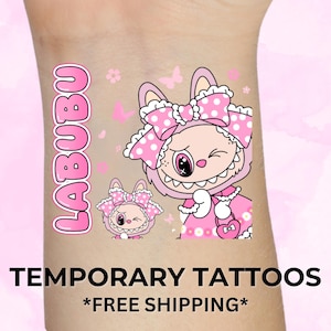 May include: Pink temporary tattoos featuring a cartoon character with a bow and polka dots. The word "LABUBU" is written vertically in pink. The text "TEMPORARY TATTOOS" is displayed in black.