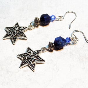 Image is of a pair of Star of David vintage charm earrings. The dangling gemstones are bicone crystals, sodalite half rounds and a silvertone spacer.