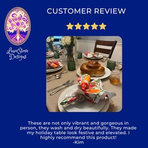 Op de afbeelding: Een prachtig gedekte eettafel met witte borden, bestek en kleurrijke servetten. De servetten hebben een levendig fruit- en groentendesign. De tafelsetting bevat een brood, bloemen en groen glaswerk. De tekst luidt "CUSTOMER REVIEW" en "Linor Store Designs".