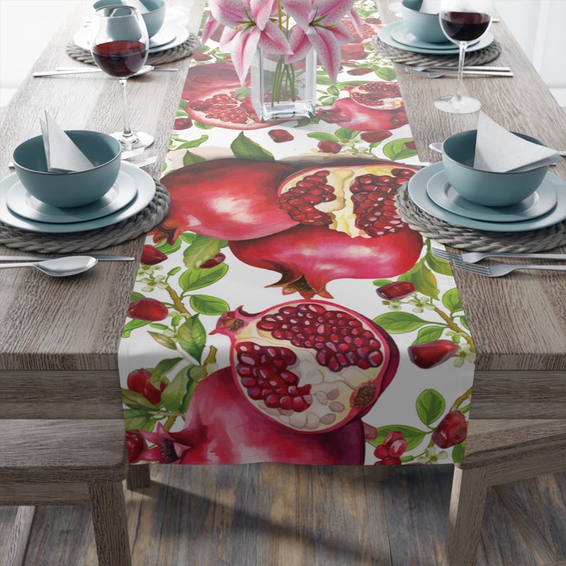 Image of a cloth table runner featuring a pattern of pomegranates, seeds, and leaves for Rosh HaShanah or Jewish New Year designed by Linda of Linorstore