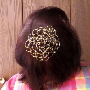 A sample kippah with small, white glass pearl beads shown on the back of my head.