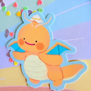 May include: An orange cartoon dragon sticker with blue wings and a white hat. The sticker has a light blue outline and is set against a pastel background with heart-shaped confetti.