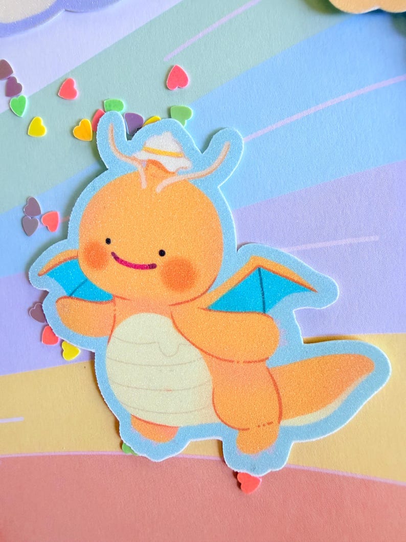 May include: An orange cartoon dragon sticker with blue wings and a white hat. The sticker has a light blue outline and is set against a pastel background with heart-shaped confetti.