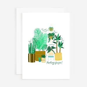 May include: A greeting card with a green and yellow illustration of potted plants. The text on the card reads "We believe in you!" and "Rooting for you!"