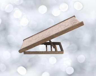May include: A wooden pet ramp with a textured surface. The ramp is angled and has a foldable base.