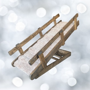 May include: A wooden pet ramp with a carpeted surface. The ramp is angled and has a handrail on one side.