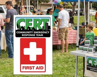 May include: A rectangular sign featuring a green CERT logo with the text Community Emergency Response Team above a red square containing a white cross and the text First Aid. The sign is mounted on a wire frame stand in an outdoor setting.