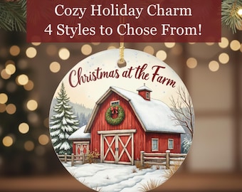 May include: A round Christmas ornament featuring a red barn with snow-covered roof and a green wreath. The ornament has the text "Christmas at the Farm" and "Cozy Holiday Charm 4 Styles to Chose From!"
