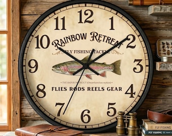May include: A round wall clock with a black frame and a cream-colored face featuring the text Rainbow Retreat Fly Fishing Tackle and Flies Rods Reels Gear. A central illustration depicts a rainbow trout with black hands indicating the time.