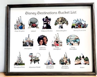 May include: A framed Disney Destinations Bucket List print featuring thirteen distinct cutouts shaped like park icons, each containing a personal photograph. The text labels include Magic Kingdom, EPCOT, Hollywood Studios, Animal Kingdom, Disney Cruise Line, Disneyland, California Adventure, Tokyo Disneyland, Tokyo DisneySea, Disneyland Paris, Adventure World, Hong Kong Disneyland, Shanghai Disneyland, and Aulani.