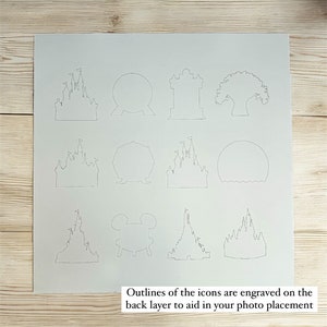 May include: A white sheet of paper with outlines of various Disney icons, including Cinderella's Castle, the Spaceship Earth, and Mickey Mouse's head. The outlines are engraved on the back layer to aid in photo placement.