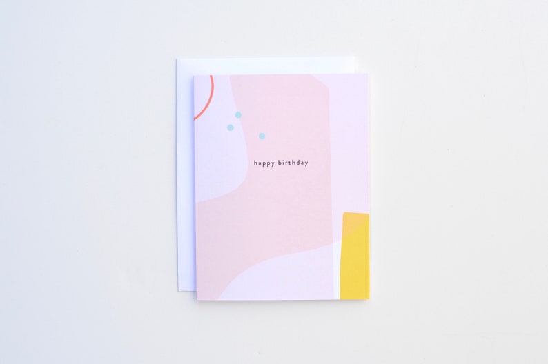 May include: A pink and white birthday card with abstract shapes and the text "happy birthday".