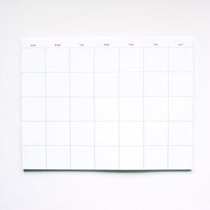 May include: A white weekly planner with a grid layout and days of the week labeled in red: Sun, Mon, Tue, Wed, Thu, Fri, Sat.
