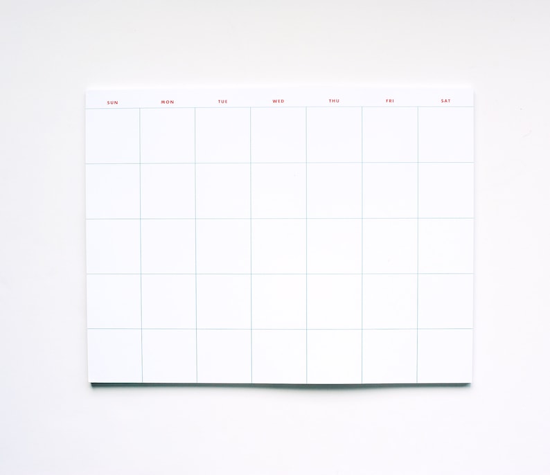 May include: A white weekly planner with a grid layout and days of the week labeled in red: Sun, Mon, Tue, Wed, Thu, Fri, Sat.