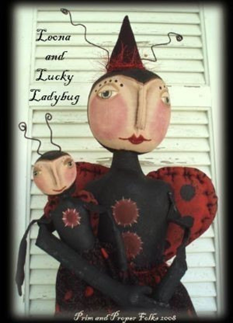 May include: Two handmade fabric dolls dressed as ladybugs. The larger ladybug doll is wearing a red hat and has a black and red polka dot dress. The smaller ladybug doll is wearing a black and red polka dot dress. The dolls are holding each other and have painted faces.