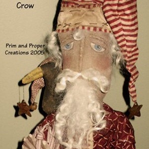 May include: A handmade rag doll Santa Claus wearing a red and white striped hat and a red and white patterned robe. He is holding a string of white yarn in his hand. A small crow doll is perched on his shoulder. The doll is titled "Holiday Blessings Santa and Crow" and "Prim and Proper Creations 2005".