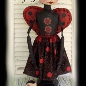 May include: Two handmade rag dolls dressed as ladybugs. The larger doll is standing and has a black dress with red polka dots. The smaller doll is sitting and has a similar dress. Both dolls have black wire arms and legs. The text "Leona and Lucky Ladybug" is written above the dolls. The text "Prim and Proper Folks 2008" is written below the dolls.