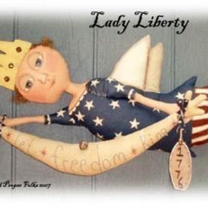 May include: A handmade doll dressed in red, white, and blue with a crown and wings. The doll is holding a scroll that says "Let Freedom Ring" and a tag that says "1776".