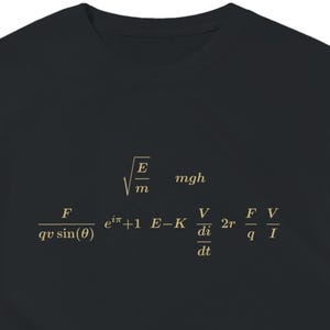 May include: A black short-sleeved t-shirt featuring a collection of physics and mathematics equations printed in a light gold color across the chest. The visible formulas include square root of E over m, mgh, F over qv sin(theta), e to the i pi plus 1, E minus K, V over di over dt, 2r, F over q, and V over I.