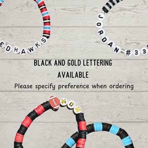 May include: Three beaded bracelets with white letter beads spelling "REDHAWKS", "JORDAN #33", and "MOM". The bracelets feature red, black, blue, and white beads. The text "BLACK AND GOLD LETTERING AVAILABLE" is also visible.