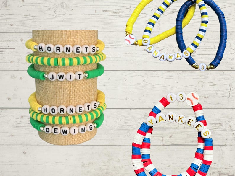 May include: A collection of colorful beaded bracelets. Some bracelets feature team names like "Hornets" and "Yankees" spelled out with white letter beads. Other bracelets have baseball-themed charms and are in team colors like blue, yellow, red, and white.