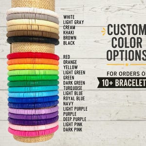 May include: A stack of colorful bracelets in various shades, including white, gray, and black, with options like red, orange, and purple. The image also displays text that reads "CUSTOM COLOR OPTIONS" and "FOR ORDERS OF 10+ BRACELETS!"