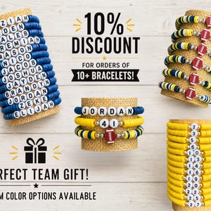 May include: Several personalized bracelets in blue, yellow, and white are displayed. Some bracelets feature names, others numbers, and some have football-themed charms. Text on the image reads "10% DISCOUNT" and "PERFECT TEAM GIFT!" with "CUSTOM COLOR OPTIONS AVAILABLE".