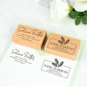 May include: Two wooden return address stamps. The first stamp is for Selina Fritter with her address and the second stamp is for Jodie Harrod with her address and a leafy design.