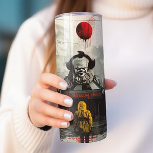 May include: A stainless steel tumbler with a graphic of Pennywise the Dancing Clown from the movie "IT". The tumbler features a red balloon and the text "the dancing clown".