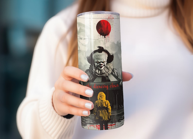 May include: A stainless steel tumbler with a graphic of Pennywise the Dancing Clown from the movie "IT". The tumbler features a red balloon and the text "the dancing clown".