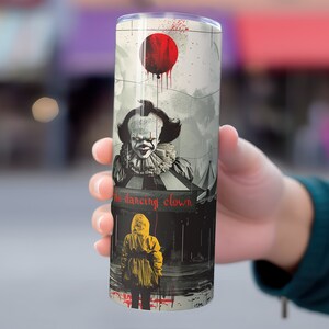 May include: A stainless steel tumbler with a graphic of Pennywise the Dancing Clown from the movie "IT". The graphic features Pennywise in a red balloon, a circus tent, and a child in a yellow raincoat.