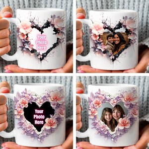 May include: White ceramic mug with a floral design surrounding a heart-shaped opening. The heart has a pink border and the text "Your Photo Here" inside. The mug is held by a hand.