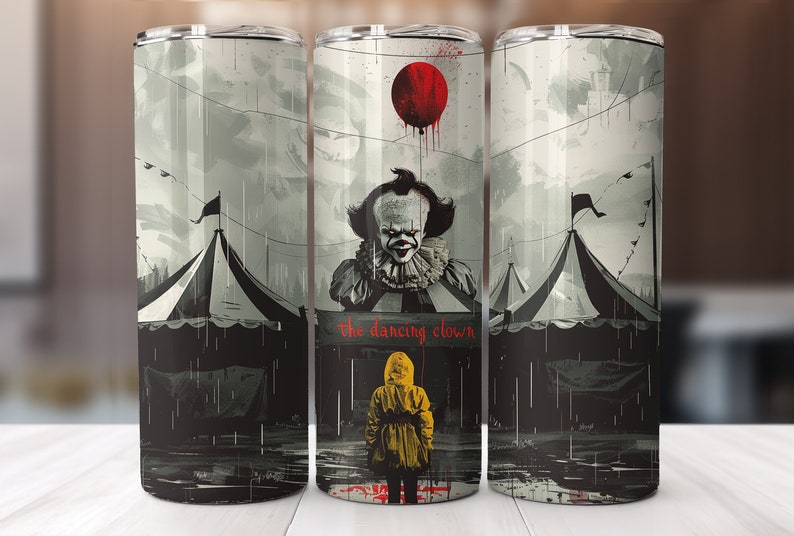 May include: A stainless steel tumbler with a black and white illustration of Pennywise the Dancing Clown from the movie "IT". The image features a red balloon, a circus tent, and the text "The Dancing Clown".