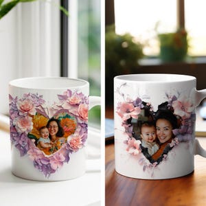 May include: White ceramic mug with a heart-shaped design featuring a floral pattern in shades of pink and purple. A photo of a mother and child is visible through the heart.