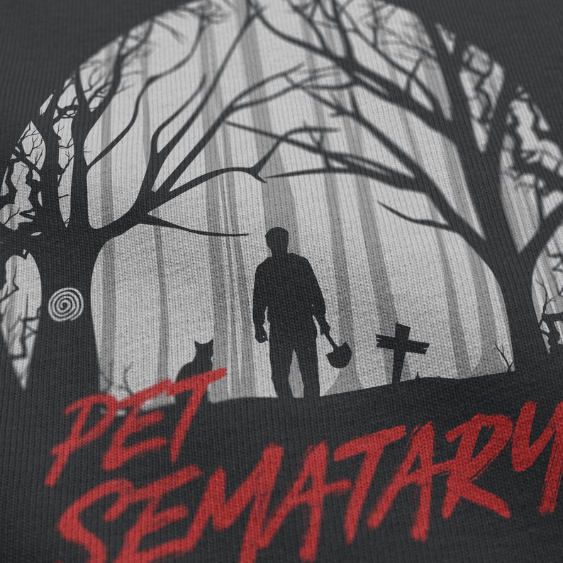 Close-up of Pet Sematary graphic on black t-shirt. Detailed horror artwork referencing the original Stephen King story and film adaptation.