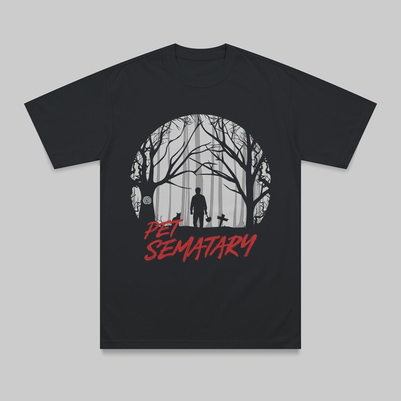 Black unisex t-shirt laid flat featuring a design inspired by Pet Sematary. Dark retro horror aesthetic referencing the Stephen King classic.