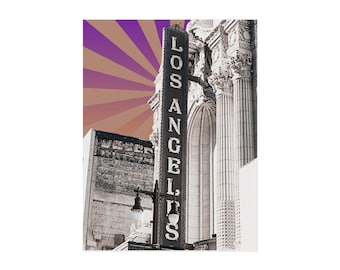 May include: A black and white image of a vintage "LOS ANGELES" sign, with a purple and brown sunburst design in the background. The sign is vertical and illuminated, with a classic font. The image captures the architecture of a building.