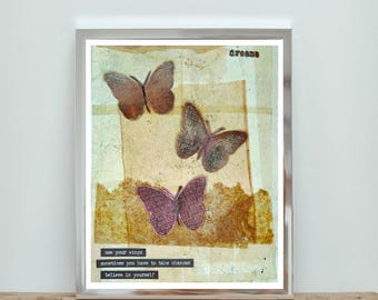May include: Framed artwork featuring three butterflies in shades of brown and purple against a textured background. The word "dreams" is at the top, with the phrases "use your wings", "sometimes you have to take chances", and "believe in yourself" at the bottom.