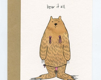 May include: A greeting card with a brown bear wearing a pink bikini and the text "bear it all".