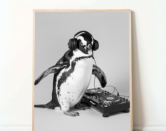May include: Black and white framed print of a penguin wearing headphones and standing next to a DJ mixer. The penguin is in a studio setting with a light gray background. The print is in a wooden frame.